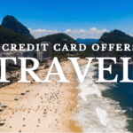 Aerial view of a sunny beach with people and waves along a coastline, with a city and green mountains in the background. Bold white text reads 'Best Credit Card Offers for Travel' with the Boldly Go logo in the bottom right corner