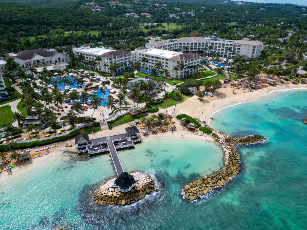 Aerial view of Hyatt Zilara Rose Hall and Hyatt Ziva Rose Hall in Montego Bay, Jamaica, showing pools, beachfront cabanas, and the turquoise Caribbean Sea.