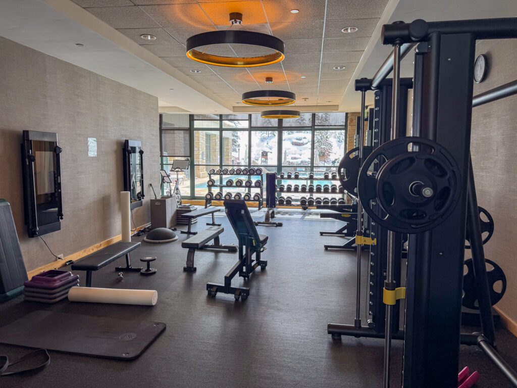 Full-service fitness center at Park Hyatt Beaver Creek with strength and cardio equipment overlooking snowy mountain views

