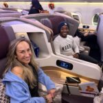 Couple seated in Singapore Airlines Business Class middle seats on the A350, showing spacious pods ideal for couples traveling together.