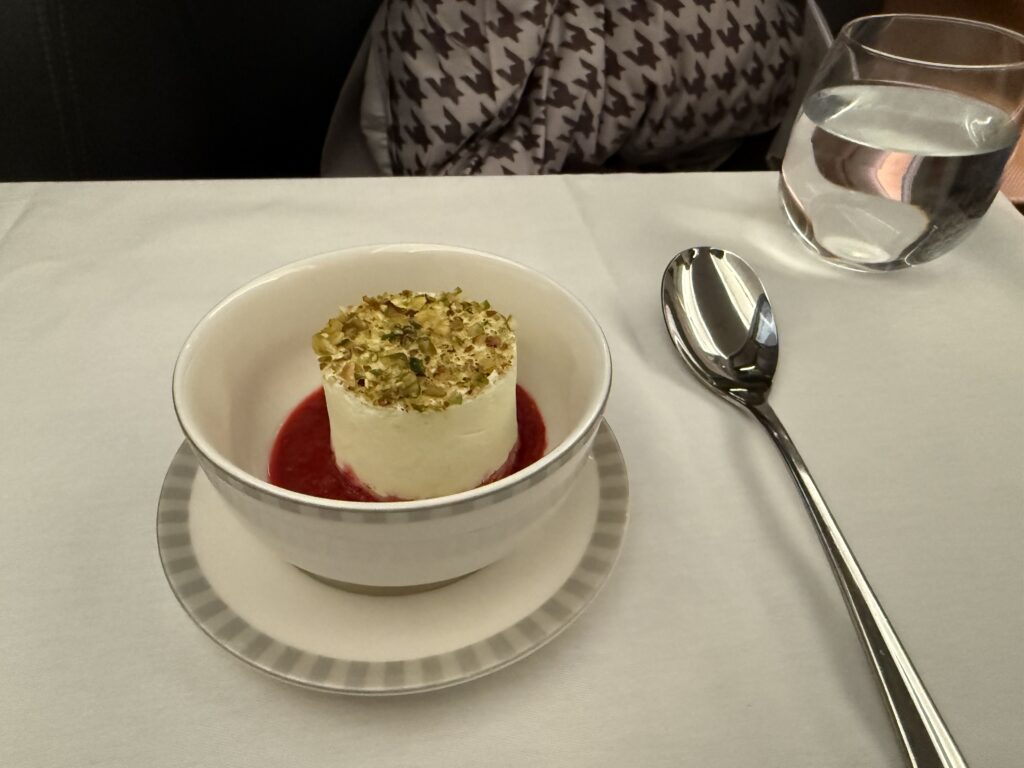 Business Class dessert with creamy mousse topped with pistachios