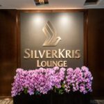 SilverKris Lounge entrance sign with orchids at Singapore Changi Airport.