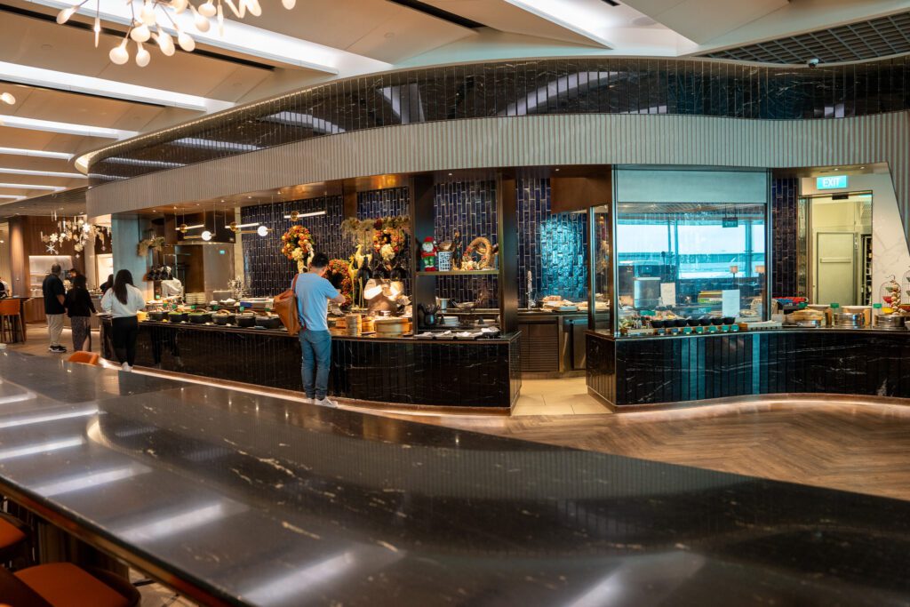 Food counters and live cooking stations inside the Singapore Airlines SilverKris Lounge at Changi Airport.