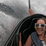 Passenger laughing inside the Hydro Attack cockpit as water splashes past during a high-speed ride in Queenstown
