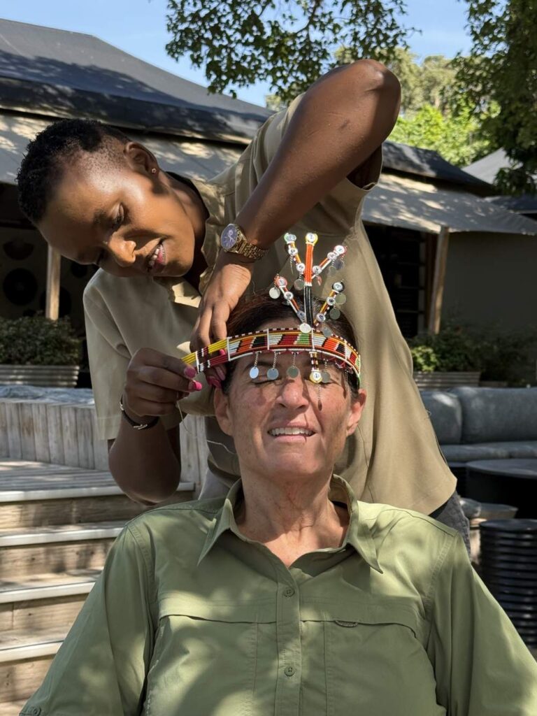 Guest participating in a Maasai beadwork cultural activity at JW Marriott Masai Mara Lodge.