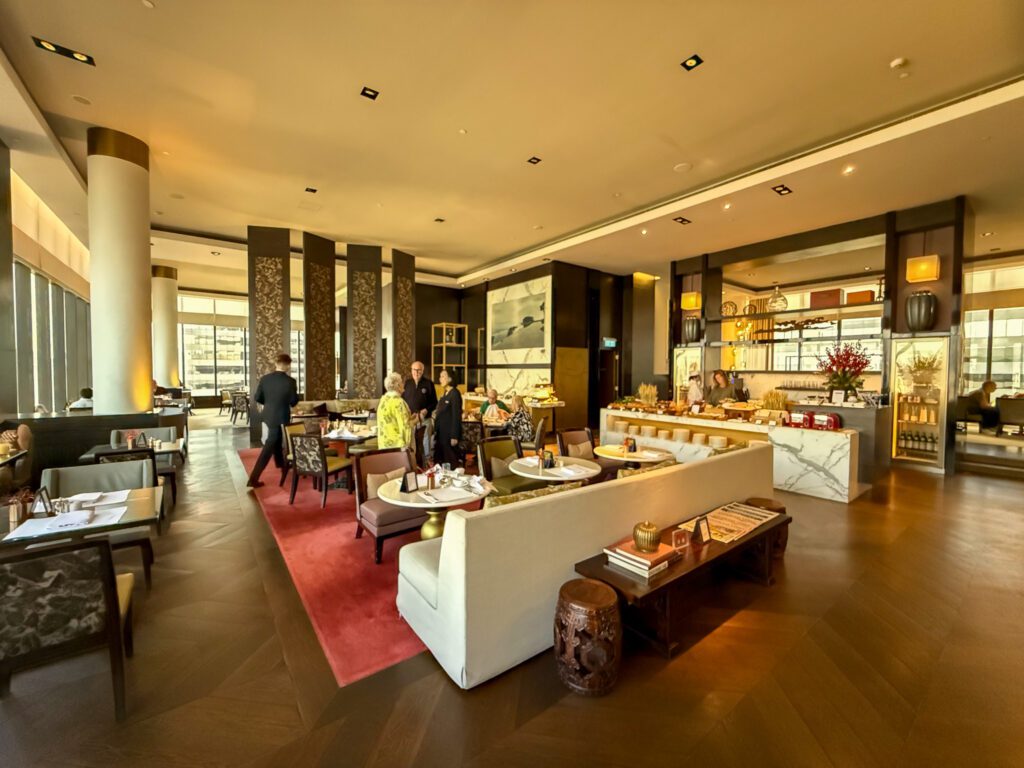 Interior of the Grand Club lounge at the Grand Hyatt Hong Kong with seating areas and buffet setup