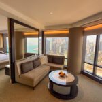 Living area of the Victoria Harbour Executive Suite at the Grand Hyatt Hong Kong with floor-to-ceiling windows overlooking Victoria Harbour featured in our Grand Hyatt Hong Kong review