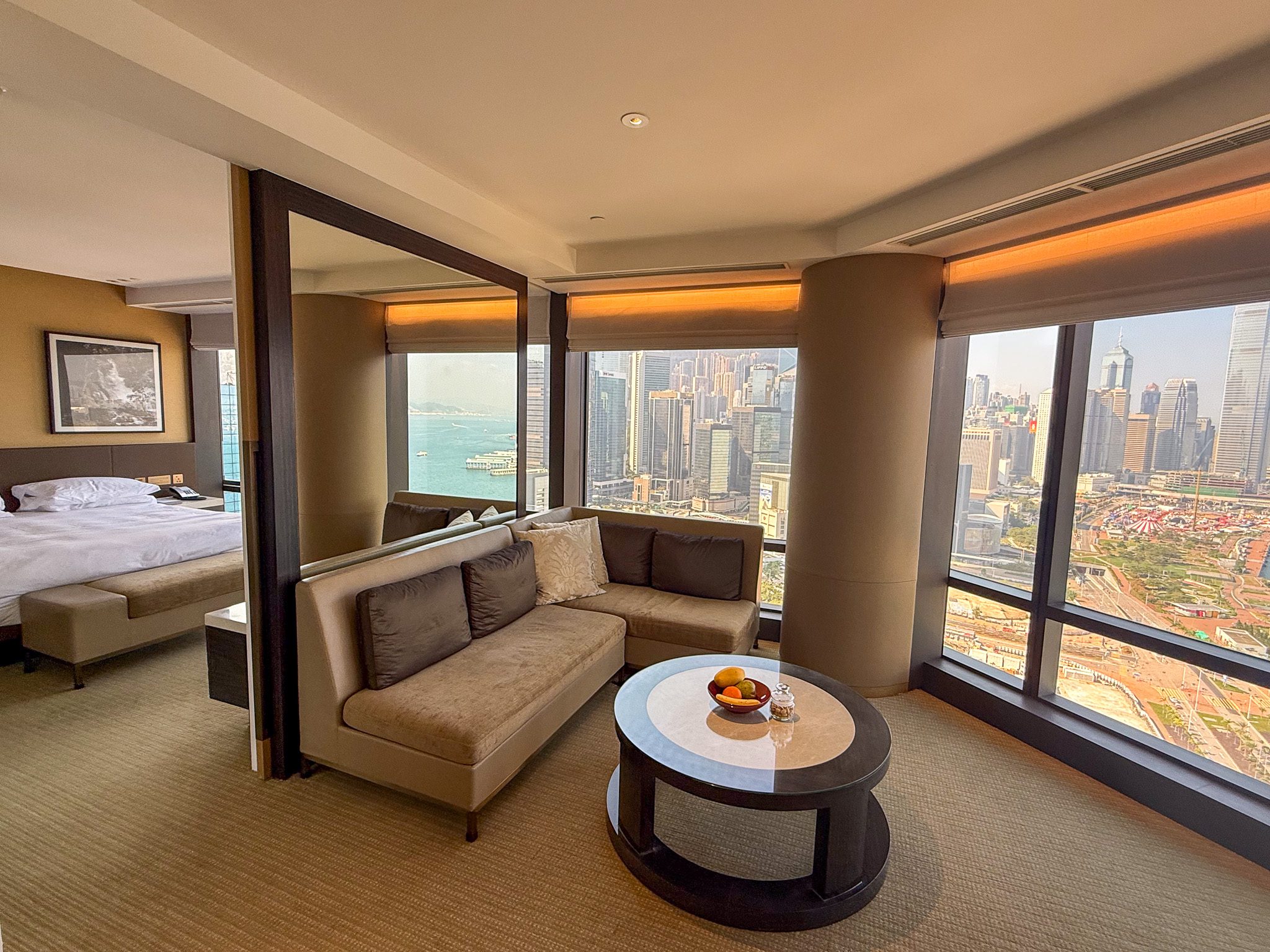Living area of the Victoria Harbour Executive Suite at the Grand Hyatt Hong Kong with floor-to-ceiling windows overlooking Victoria Harbour featured in our Grand Hyatt Hong Kong review