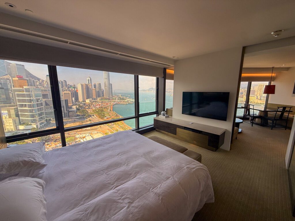 Bedroom in the Victoria Harbour Executive Suite at the Grand Hyatt Hong Kong with sweeping views of Victoria Harbour and the city skyline