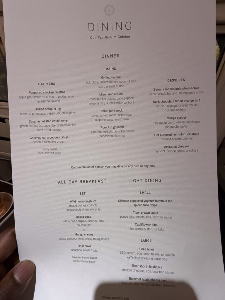 Fiji Airways A330 business class dinner menu featuring Kalua pork neck, charred corn coconut soup, and banana macadamia cheesecake.