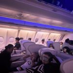 Fiji Airways A330 business class cabin at night with 2-2-2 seat configuration and passengers resting during the Hong Kong to Nadi flight.