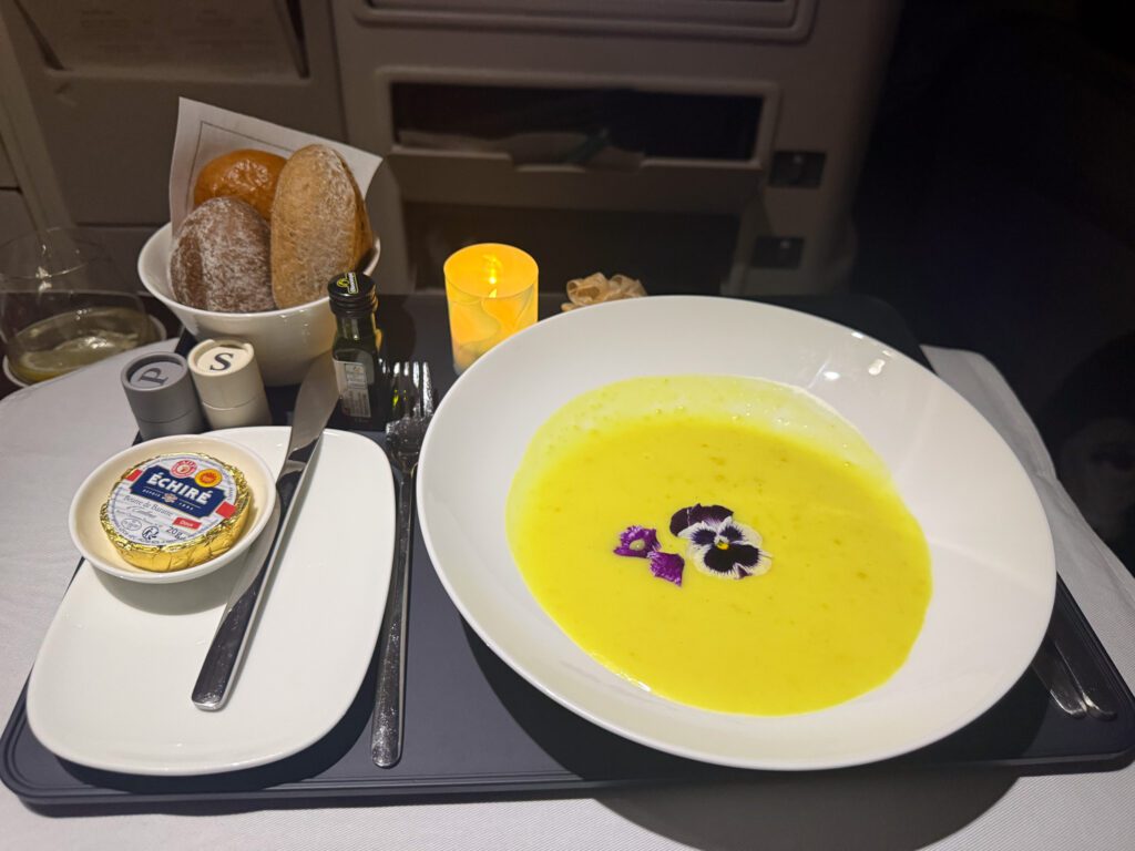 Fiji Airways A330 business class starter of charred corn coconut soup with coconut turmeric cream served during dinner service.