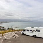 Luxury campervan parked at Kaikōura Lookout in New Zealand, overlooking the coastline during a two-week campervan road trip.