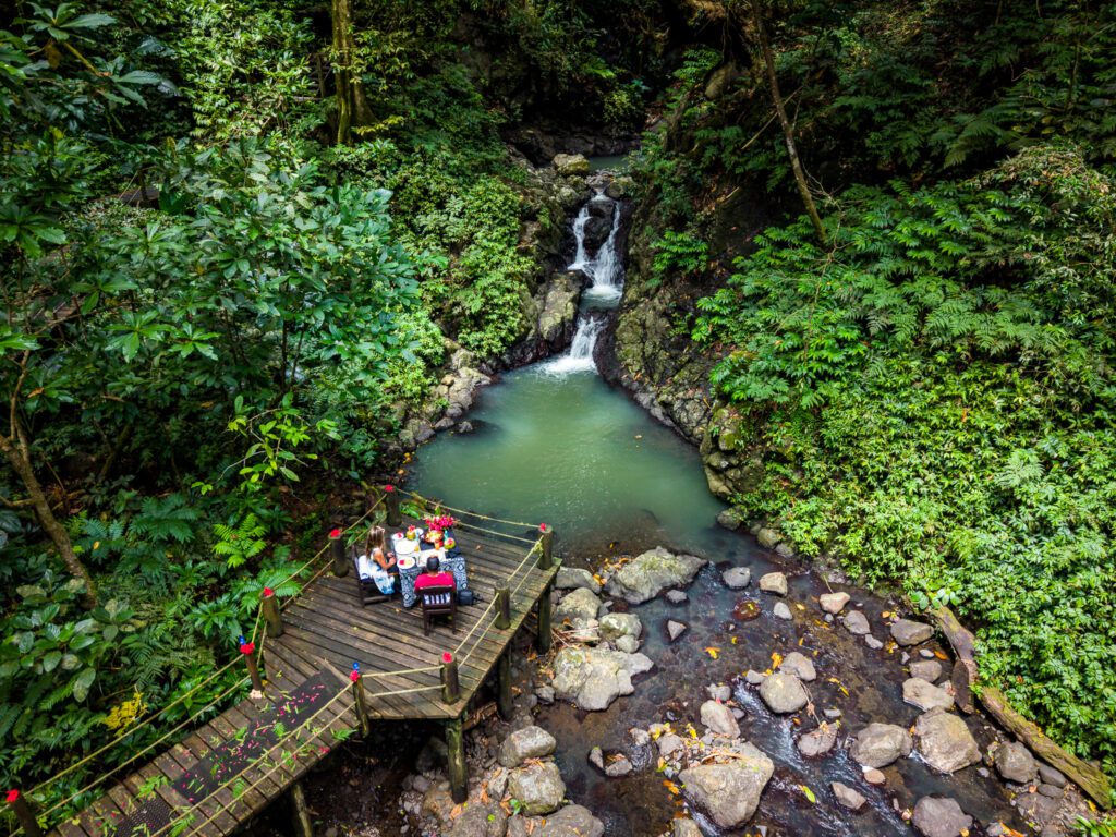 Couple enjoying a private picnic beside a jungle waterfall arranged by Namale Resort & Spa in Fiji.
