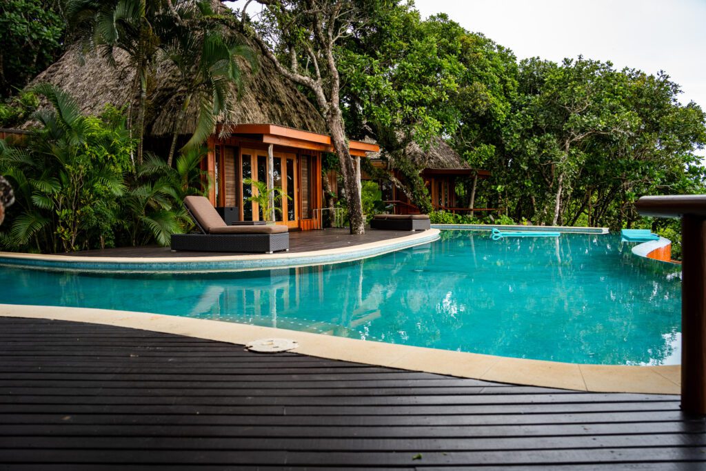 Private villa infinity pool and deck surrounded by tropical greenery at Namale Resort & Spa in Fiji.