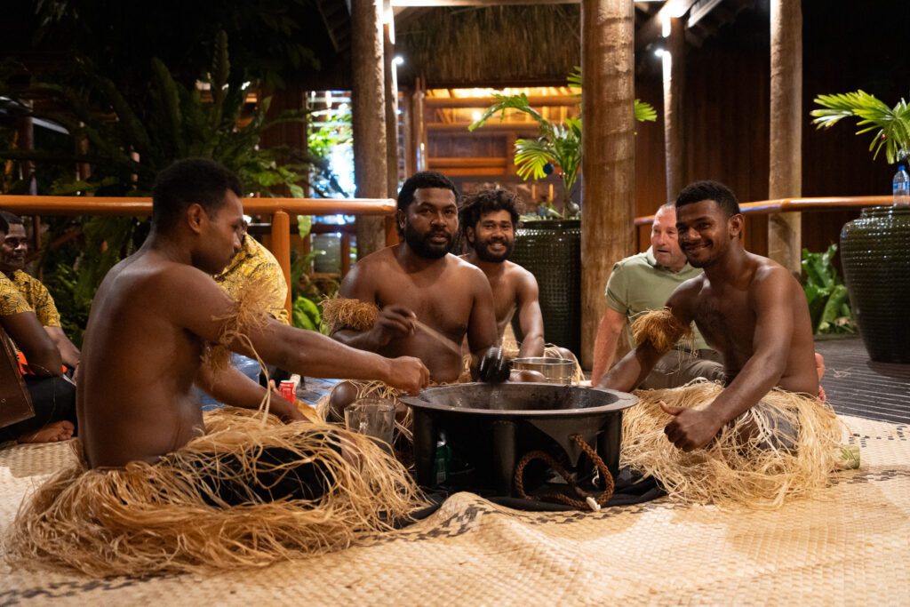 Resort staff performing a traditional Fijian kava ceremony during an evening cultural experience at Namale Resort in Fiji.