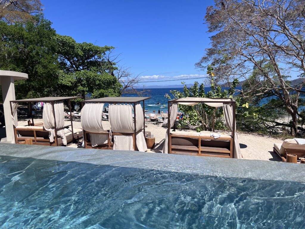 Beach cabanas and lounge chairs overlooking the ocean at Waldorf Astoria Cacique Costa Rica