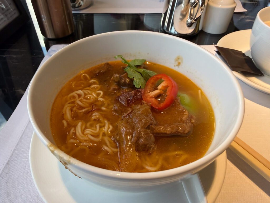Bowl of Hong Kong style beef noodle soup with tender beef and broth served at a local restaurant