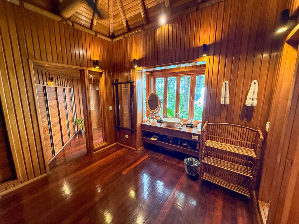 Spacious wooden dressing area inside a luxury villa at Namale Resort in Fiji with polished hardwood floors and tropical design.