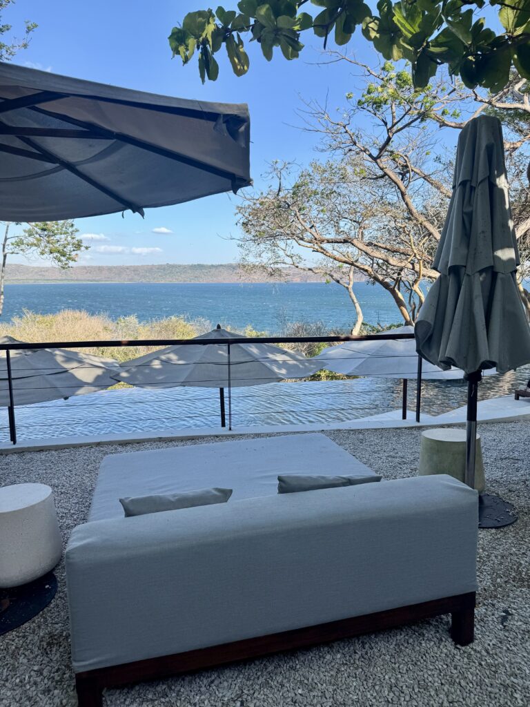 Oceanfront daybed seating at Andaz Papagayo resort pool in Costa Rica