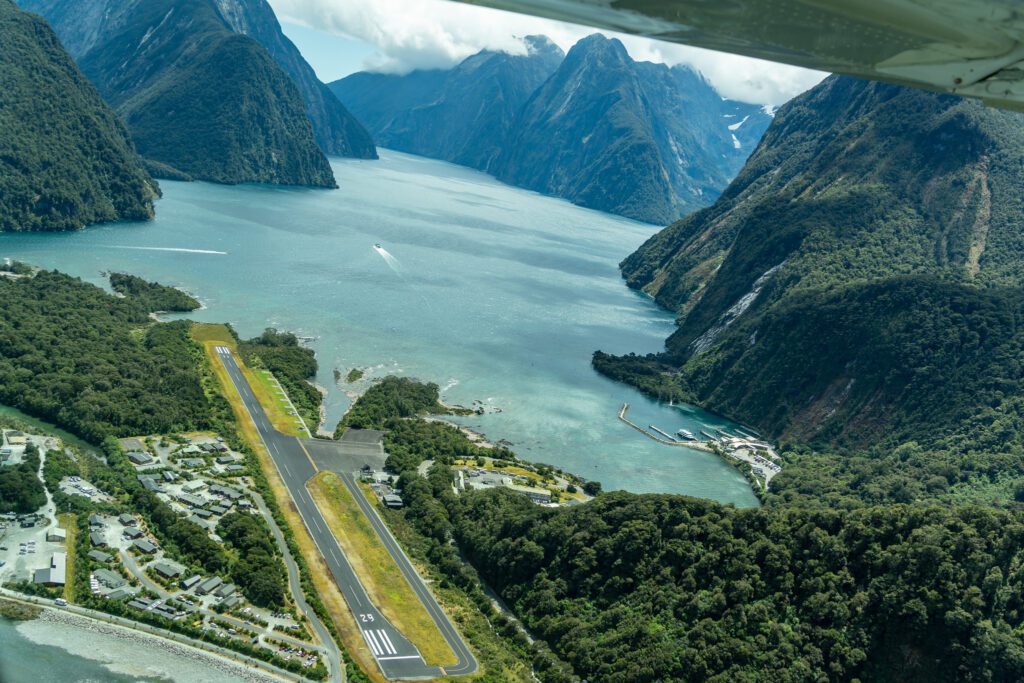 Milford Sound runway and fjord seen from above during a scenic flight landing approach
