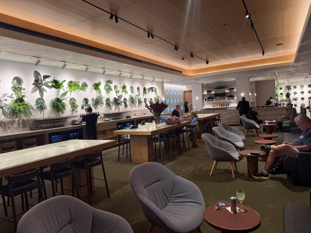 Qantas Auckland Business Class Lounge bar area with seating and plant wall design