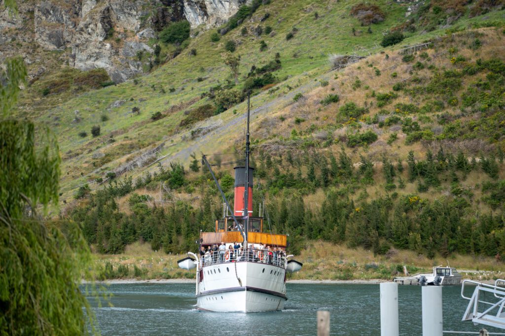 TSS Earnslaw steamship approaching Walter Peak across Lake Wakatipu in Queenstown