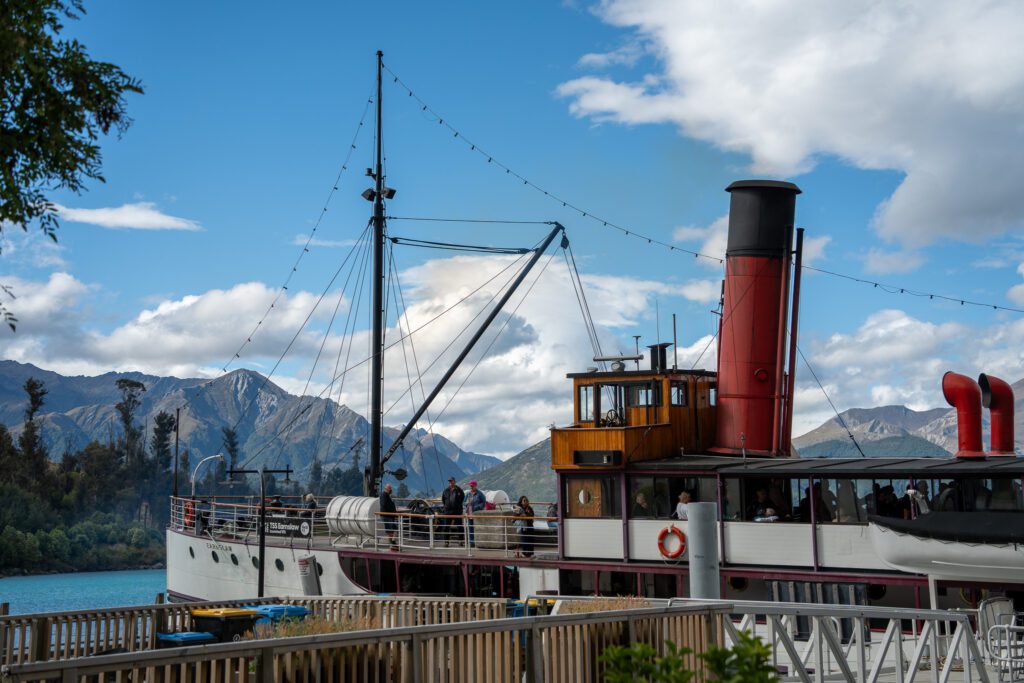 Side view of the TSS Earnslaw steamship with mountains in the background in Queenstown