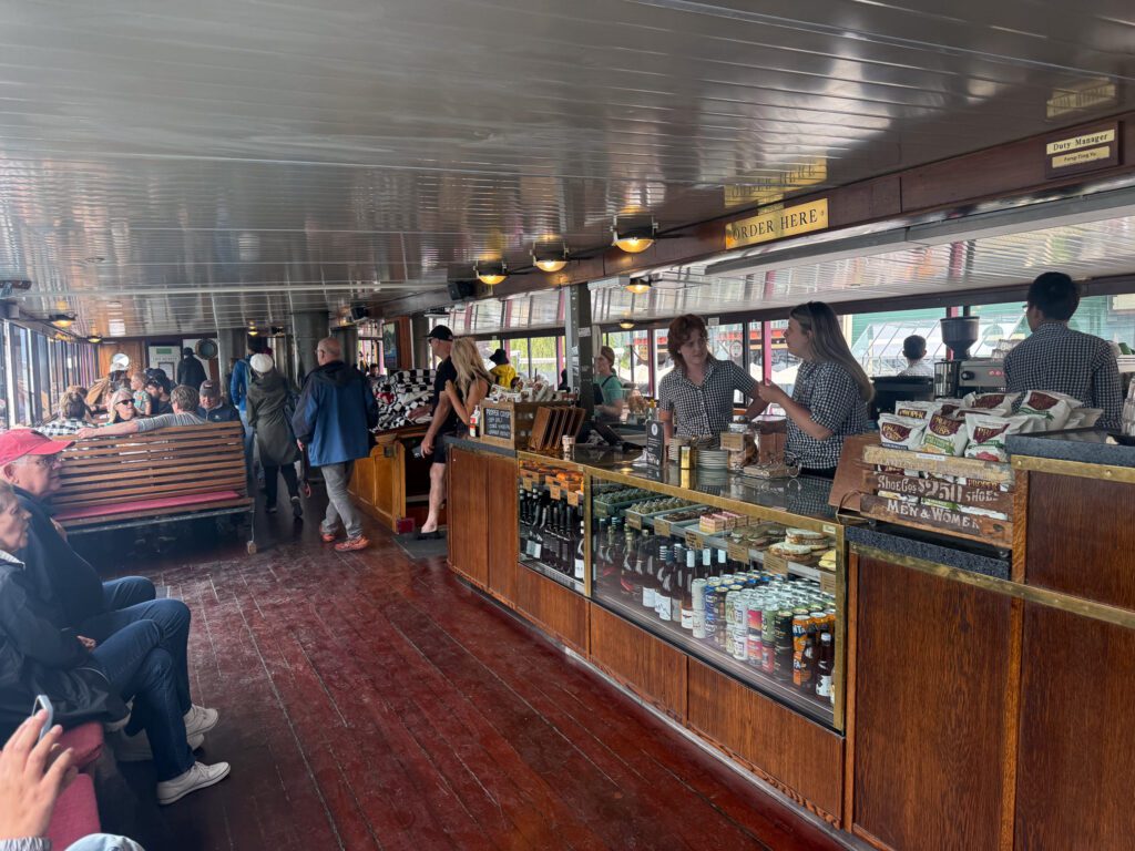 Interior of the TSS Earnslaw showing café, bar, and seating area during the cruise