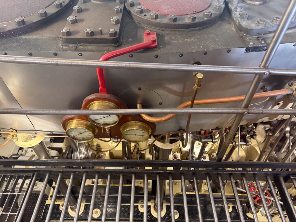 Close-up of gauges and machinery inside the TSS Earnslaw steam engine room