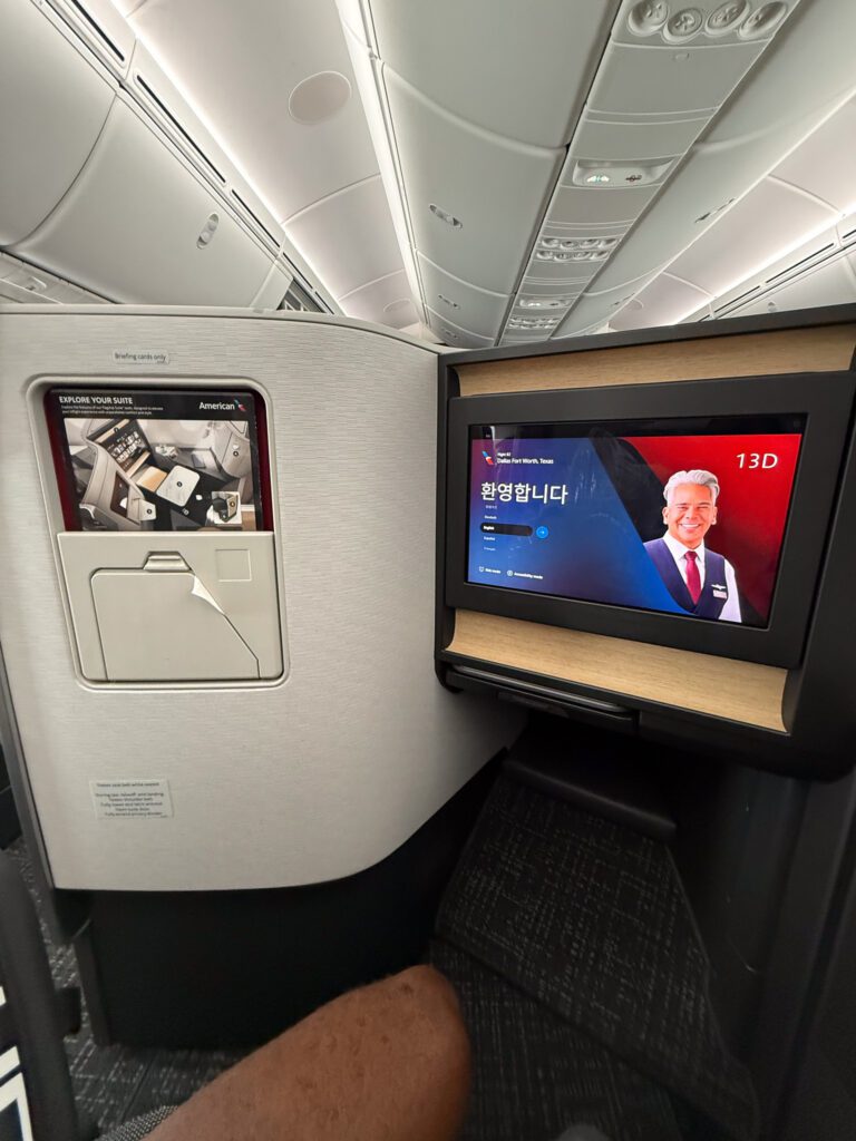American Airlines 787-9 business class seat with inflight entertainment screen and footwell