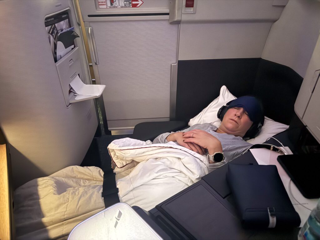 American Airlines 787-9 business class lie-flat bed with passenger sleeping