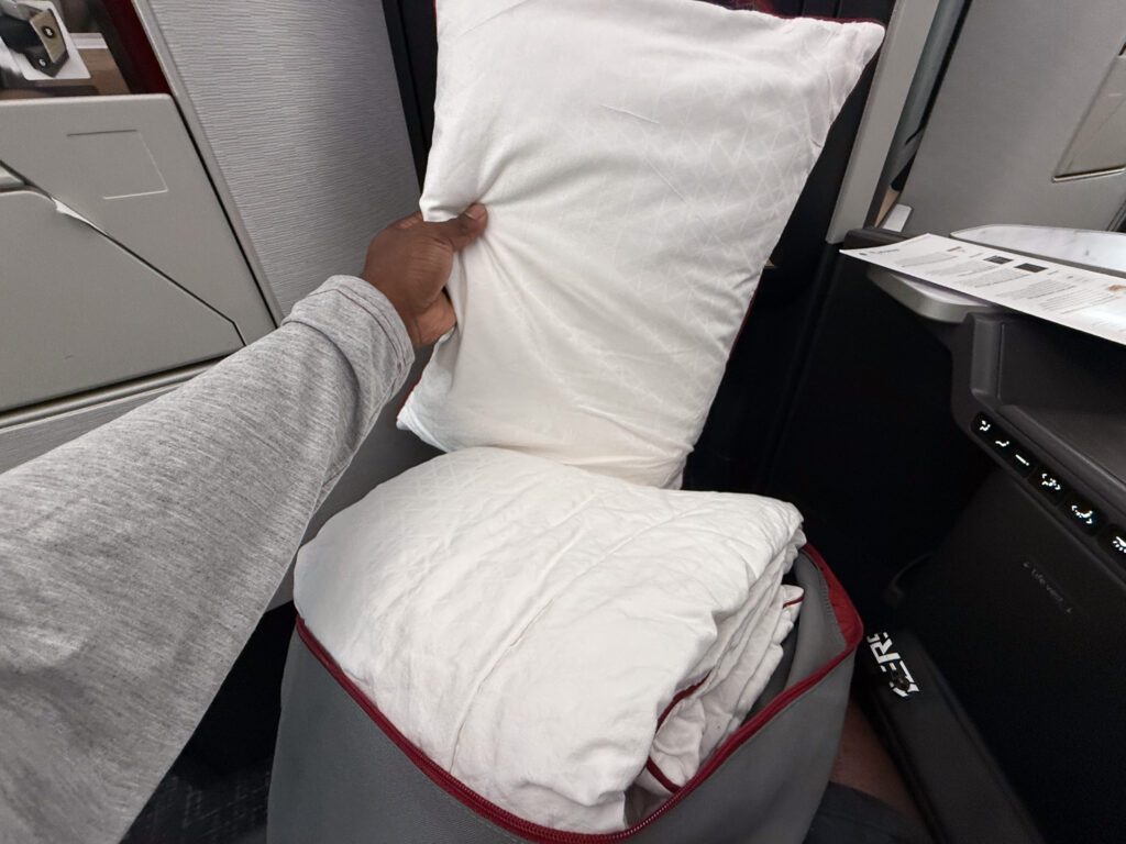 American Airlines business class bedding kit with pillow and blanket on 787-9