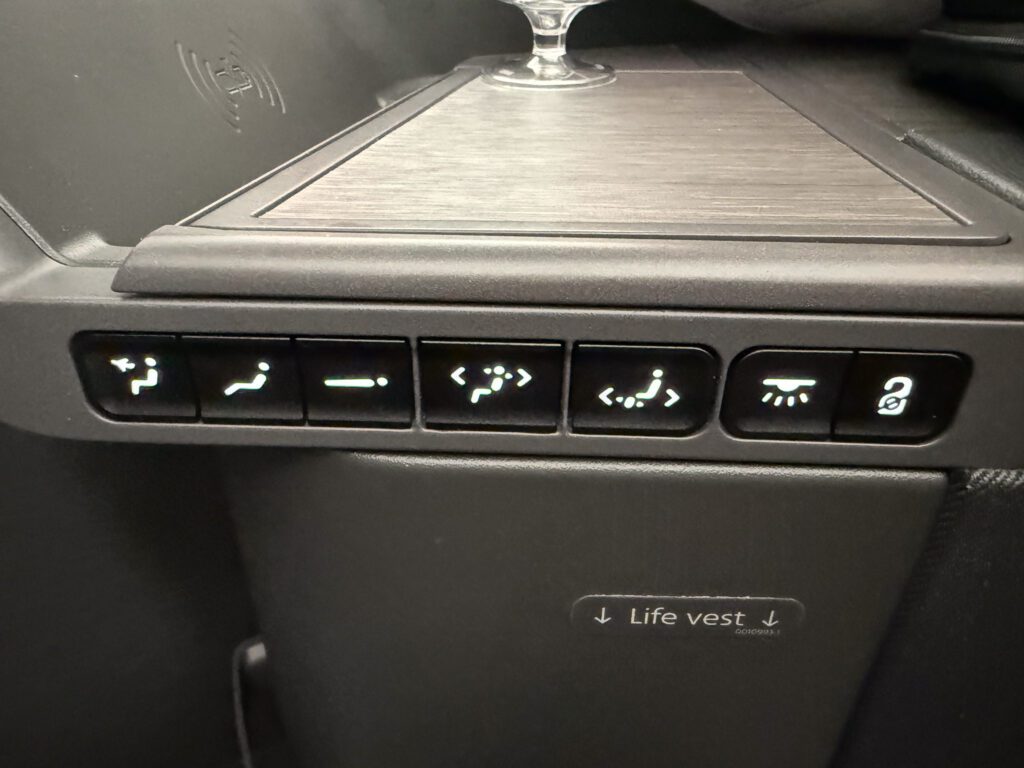American Airlines business class seat control panel with recline and lighting buttons