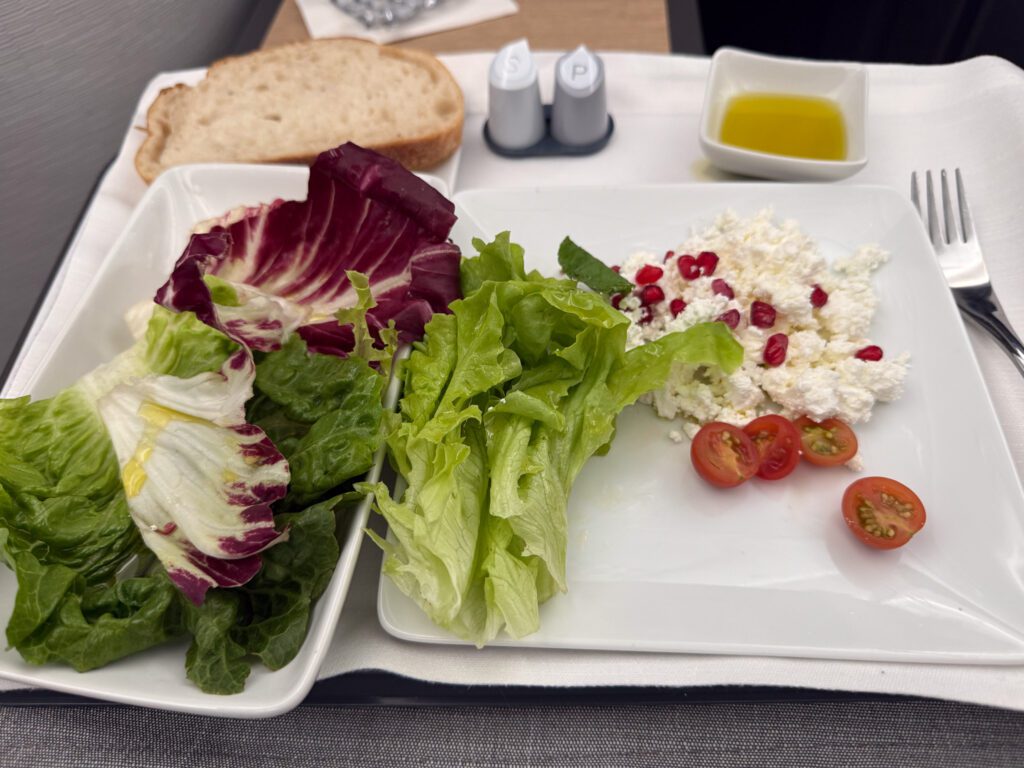 American Airlines business class meal with salad and cheese starter on 787-9
