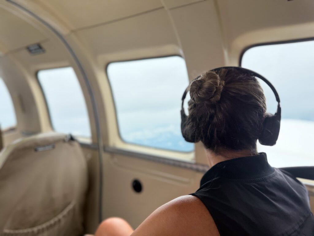 Woman looking out window during Nanuku Resort Fiji private air transfer flight over Viti Levu