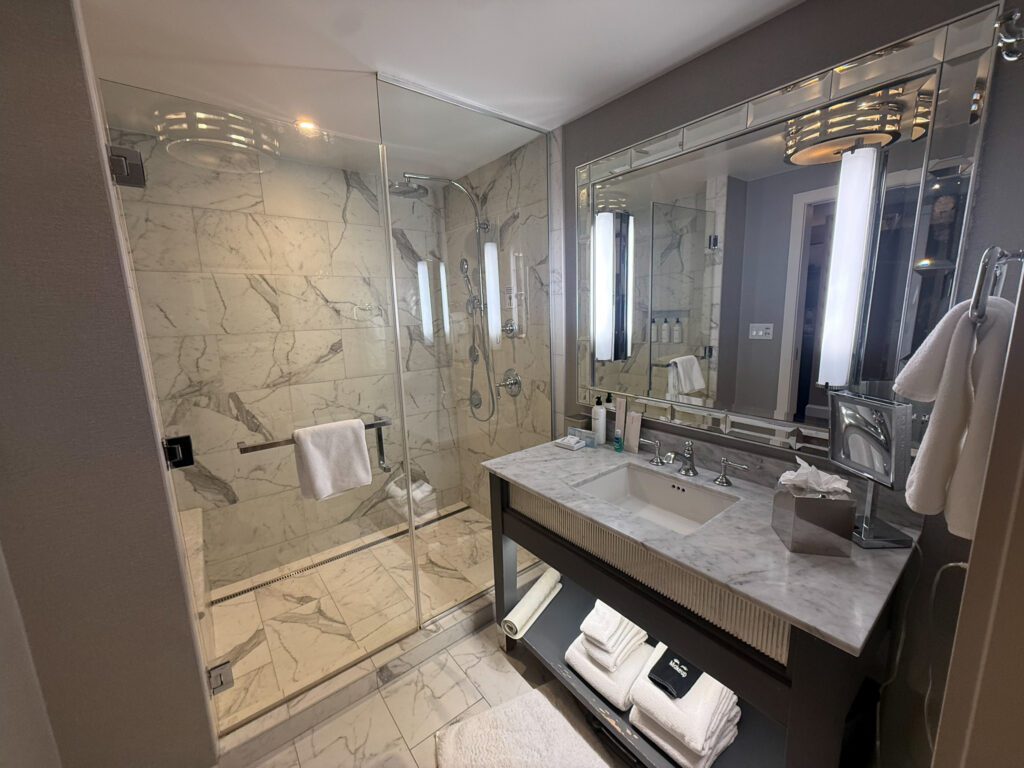 Marble bathroom in a Grand Suite at Grand Hyatt Vail featuring a walk-in shower with body jets