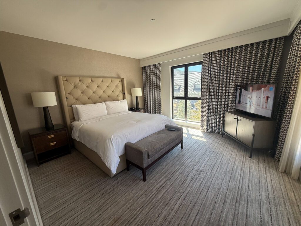 King bedroom in a Grand Suite at Grand Hyatt Vail with mountain views and separate living space