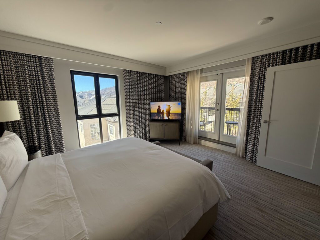 Grand Suite bedroom at Grand Hyatt Vail featuring a king bed, balcony access, and mountain views
