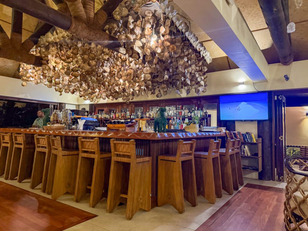 Nanuku Resort Fiji lobby bar with handcrafted shell decor and tropical luxury atmosphere