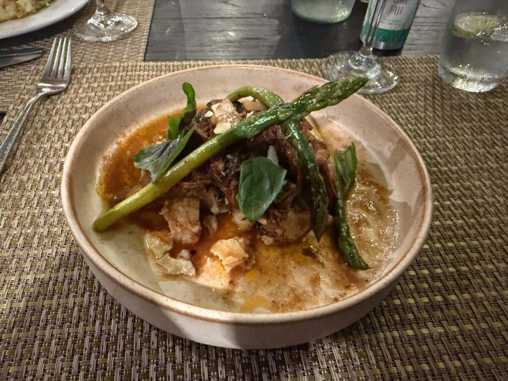 Fine dining dinner entrée with asparagus and braised meat at Nanuku Resort Fiji restaurant