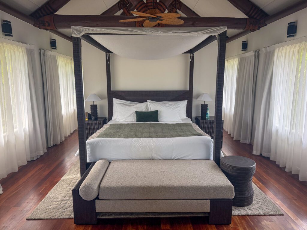 King canopy bed inside Nanuku Resort Fiji standard room villa with vaulted ceilings