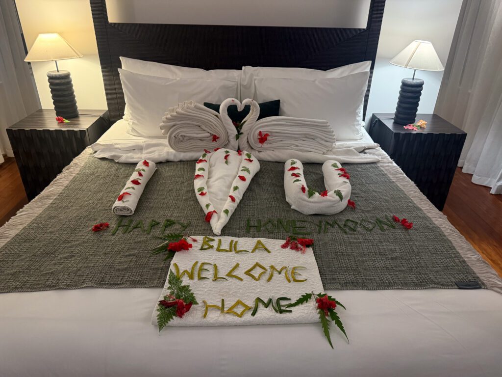 Honeymoon towel art and floral welcome decoration on king bed at Nanuku Resort Fiji