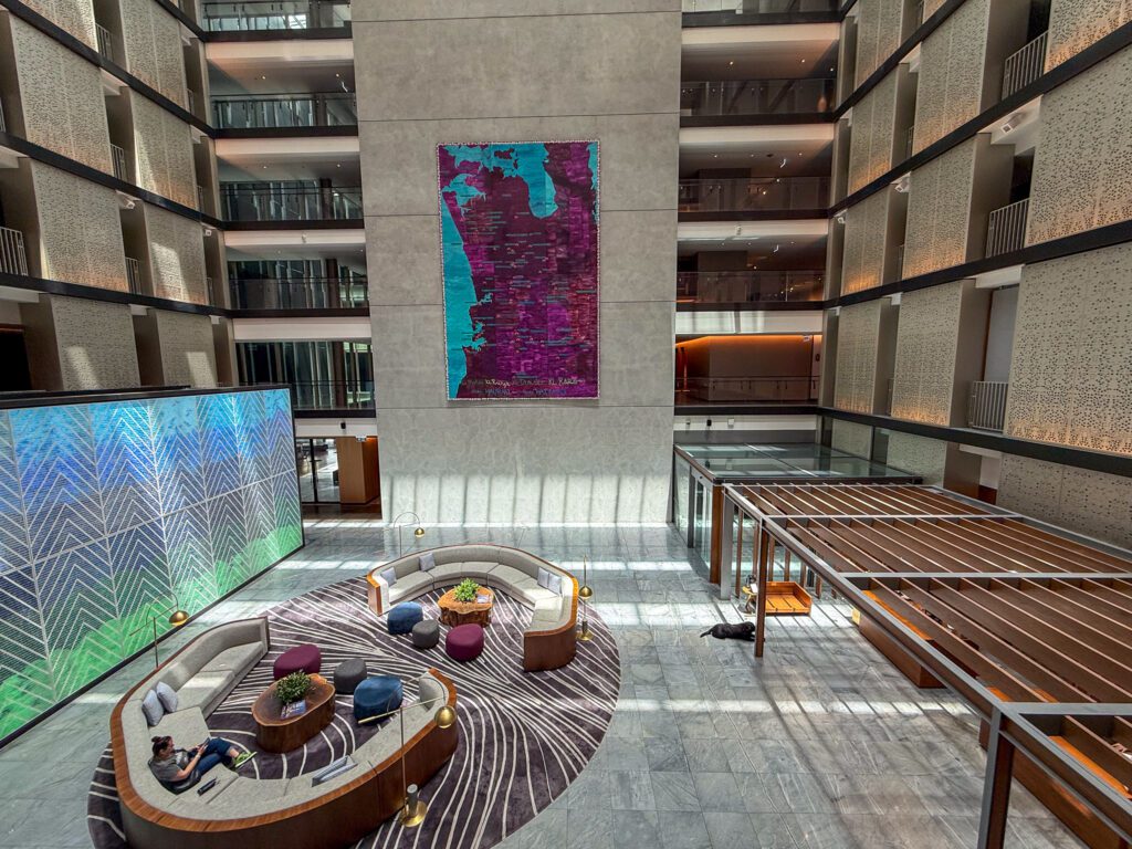 Multi-story atrium lobby at Park Hyatt Auckland featuring contemporary artwork, lounge seating, and modern luxury design