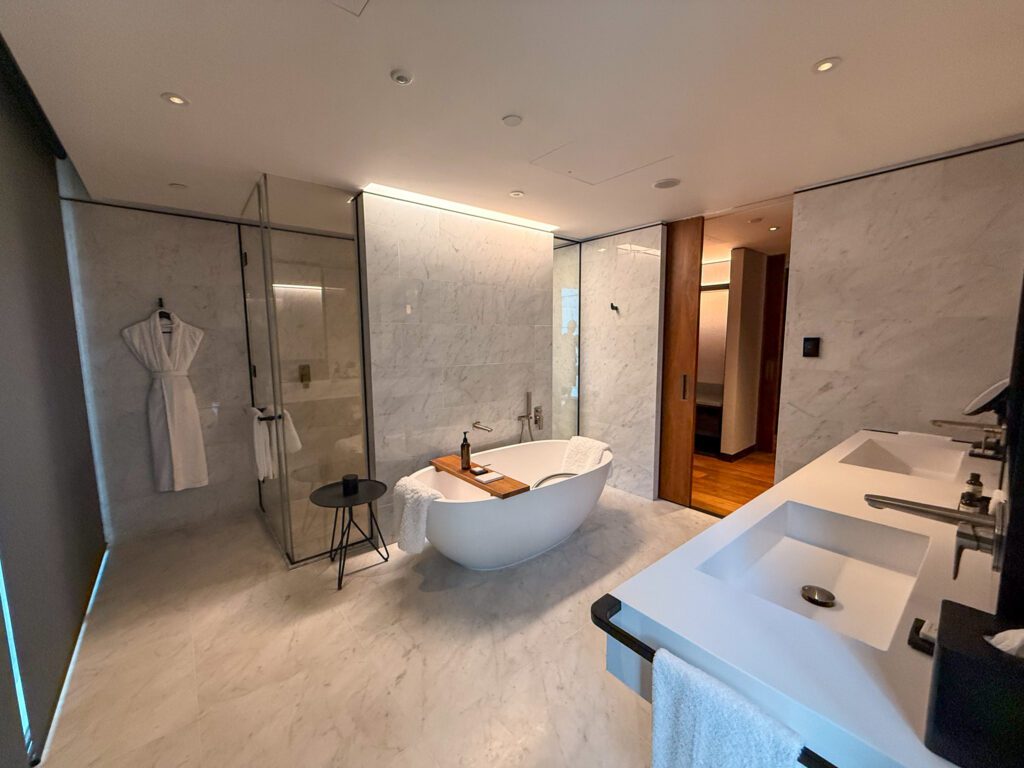 Spacious marble bathroom in the Park Hyatt Auckland Park Suite with soaking tub, double vanity, and walk-in shower